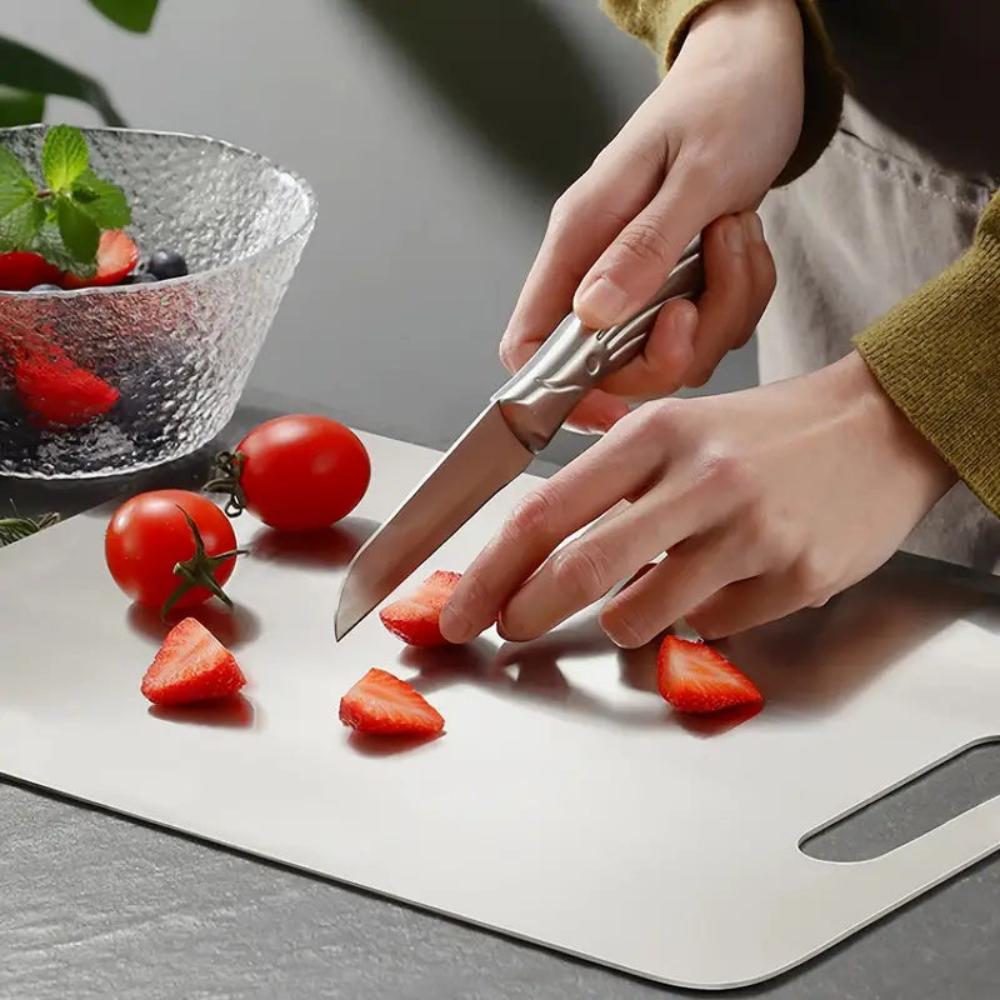 Slicing tomatoes on the stainless steel cutting board