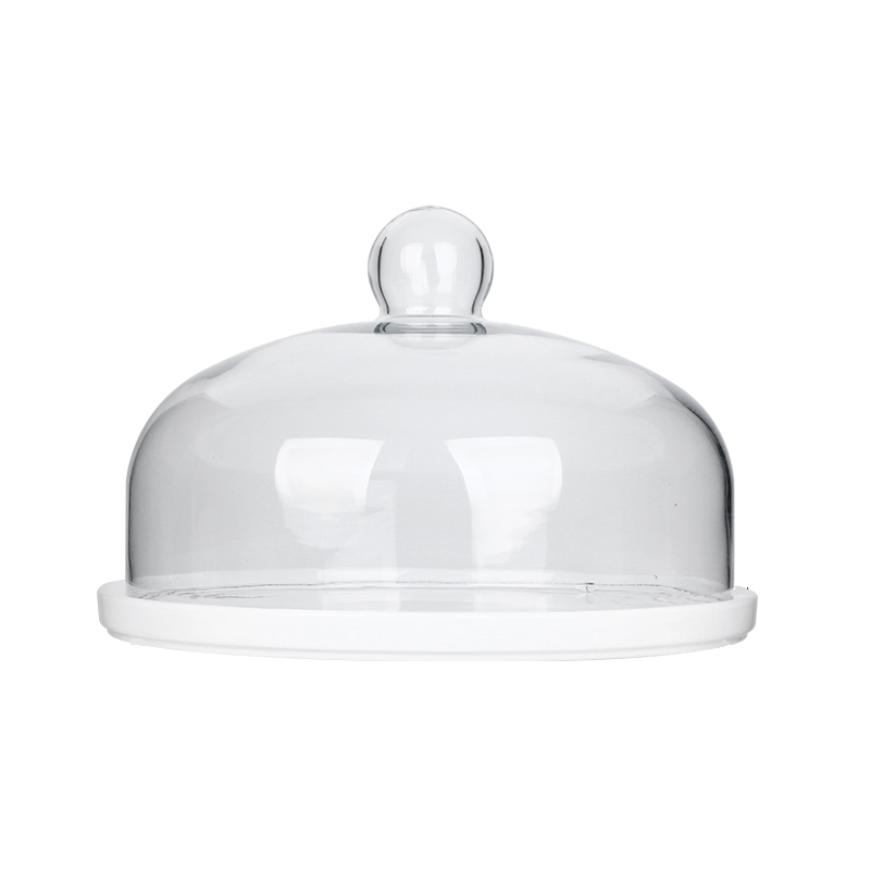 White cake plate with a clear glass dome on a white background
