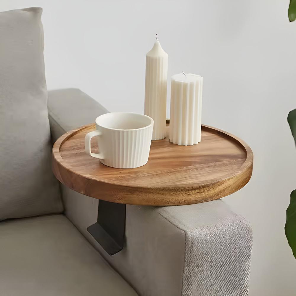 Wood sofa arm tray holding a mug and candles