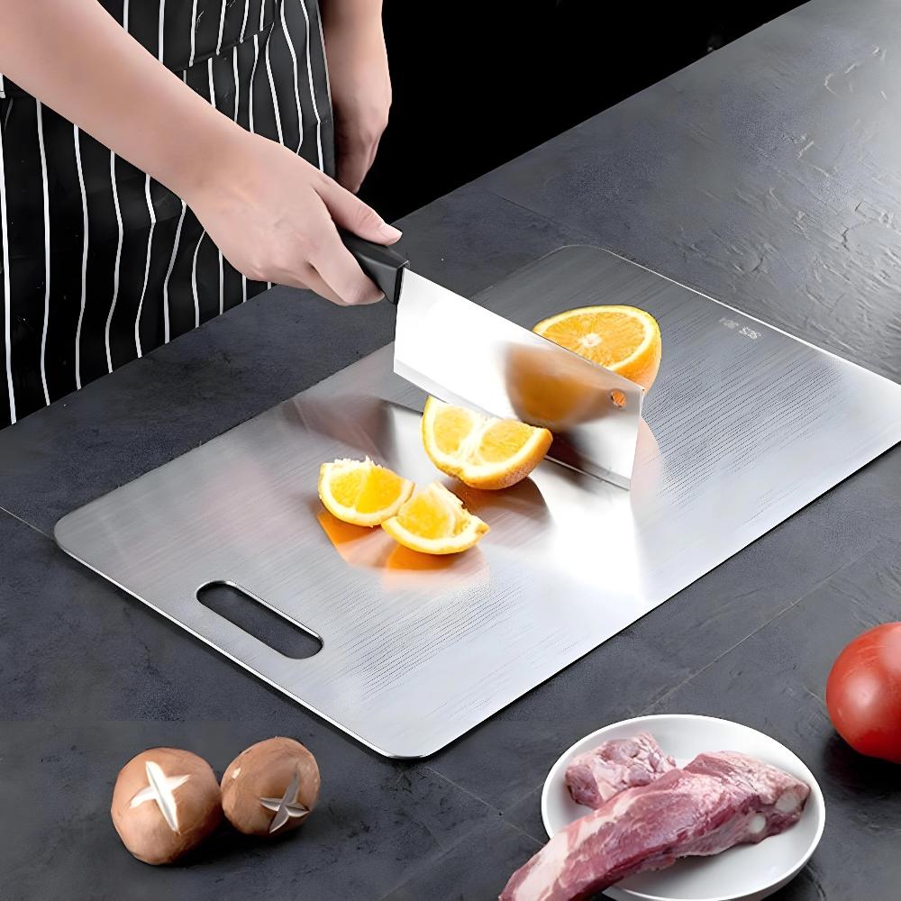 Cutting oranges on the steel cutting board with handle