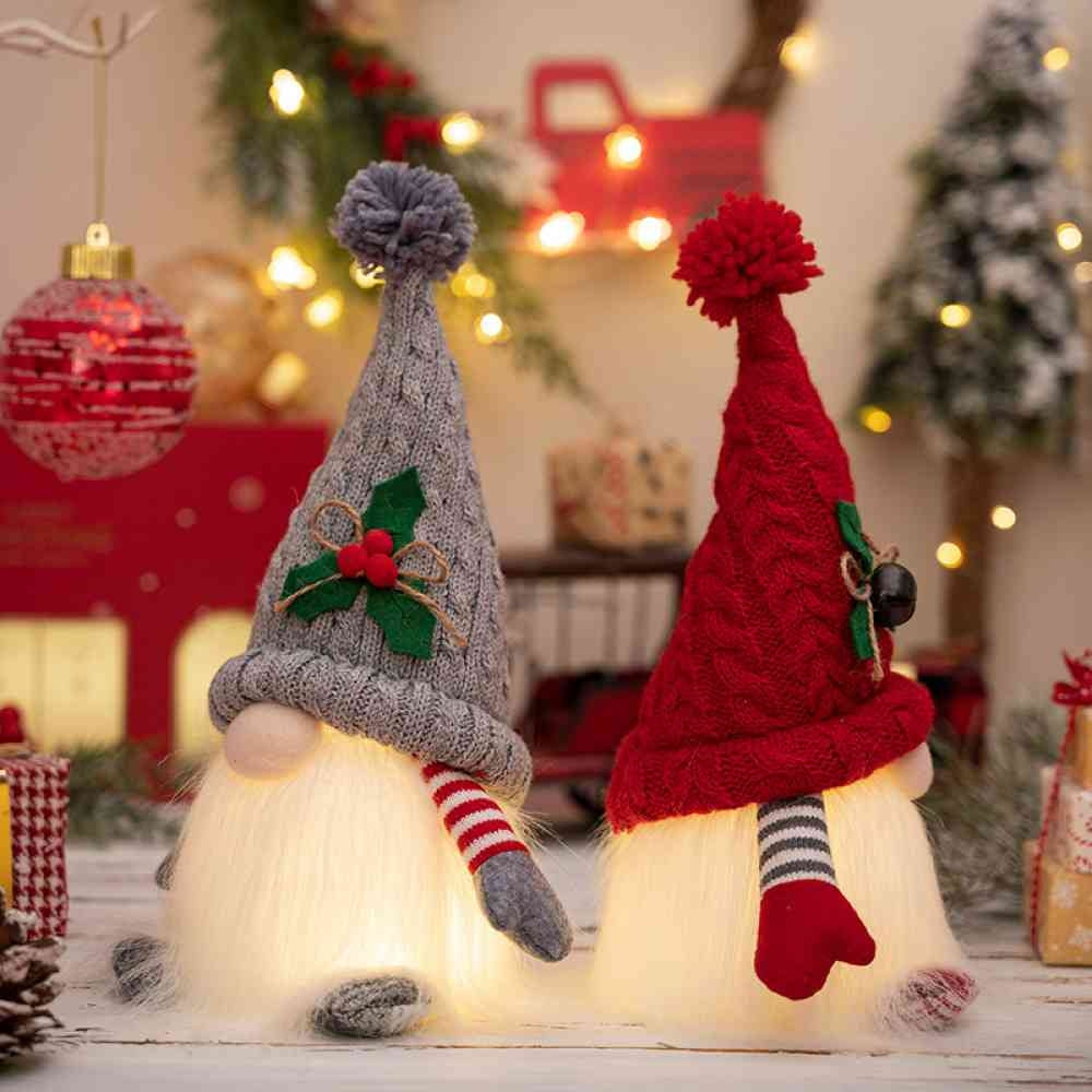 Gray and red light-up Christmas gnomes side by side