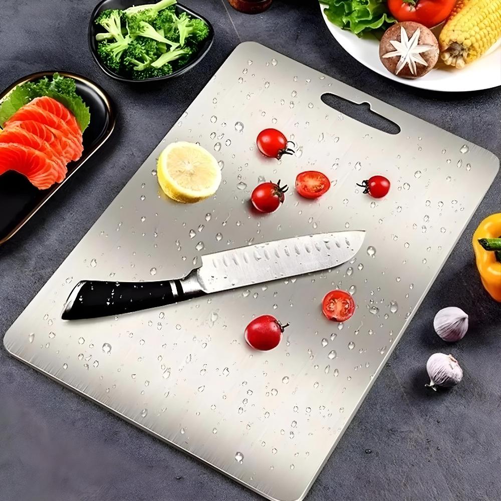 Stainless steel cutting board with tomatoes, lemon and a chef knife
