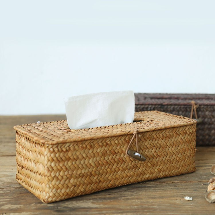 Woven rattan tissue box cover with a tissue on a wooden table