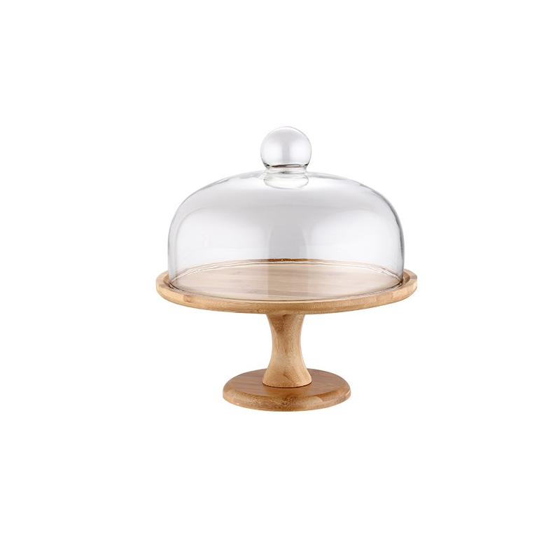 Wood footed cake stand with a glass dome on a white background