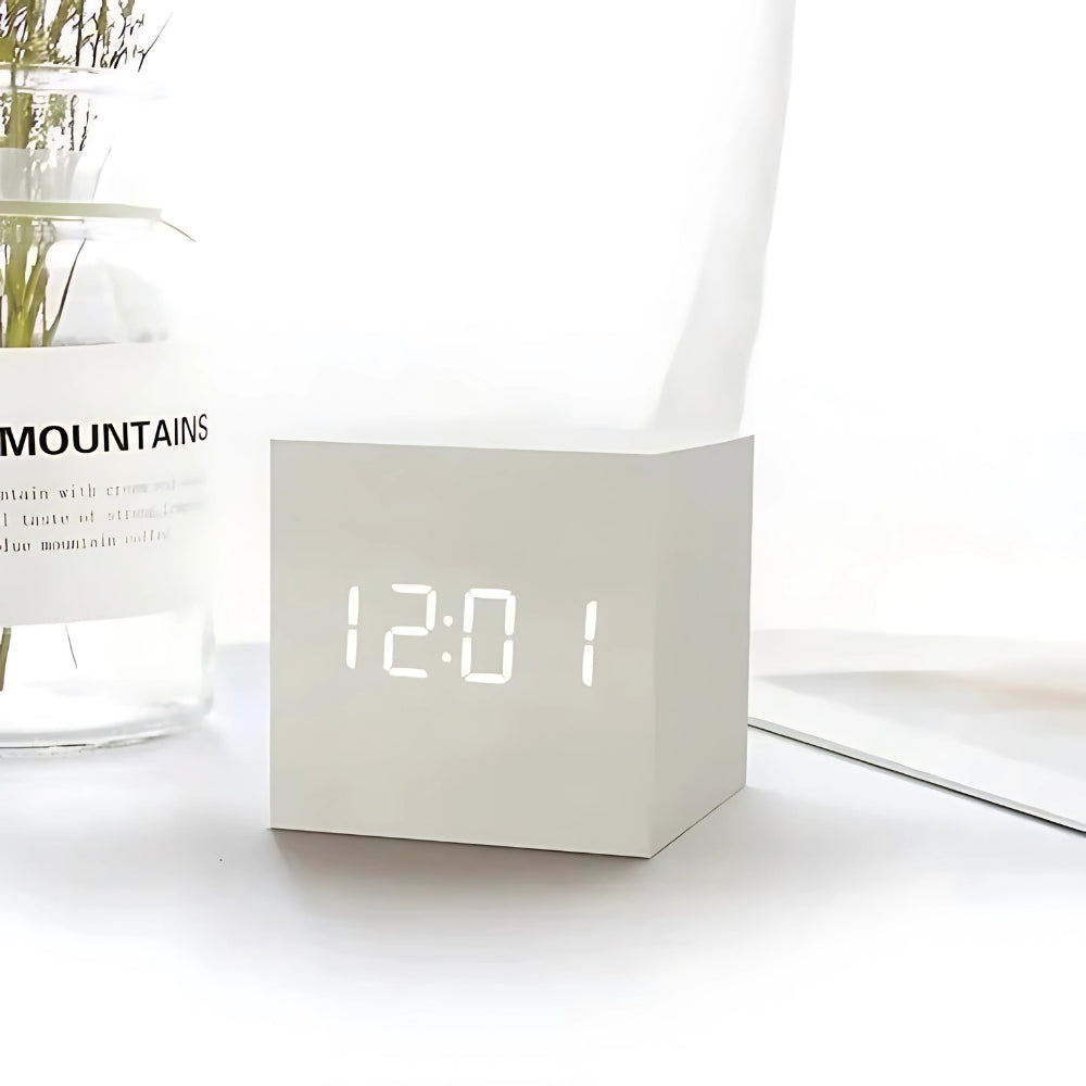 Cube LED alarm clock in Ivory White on a desk