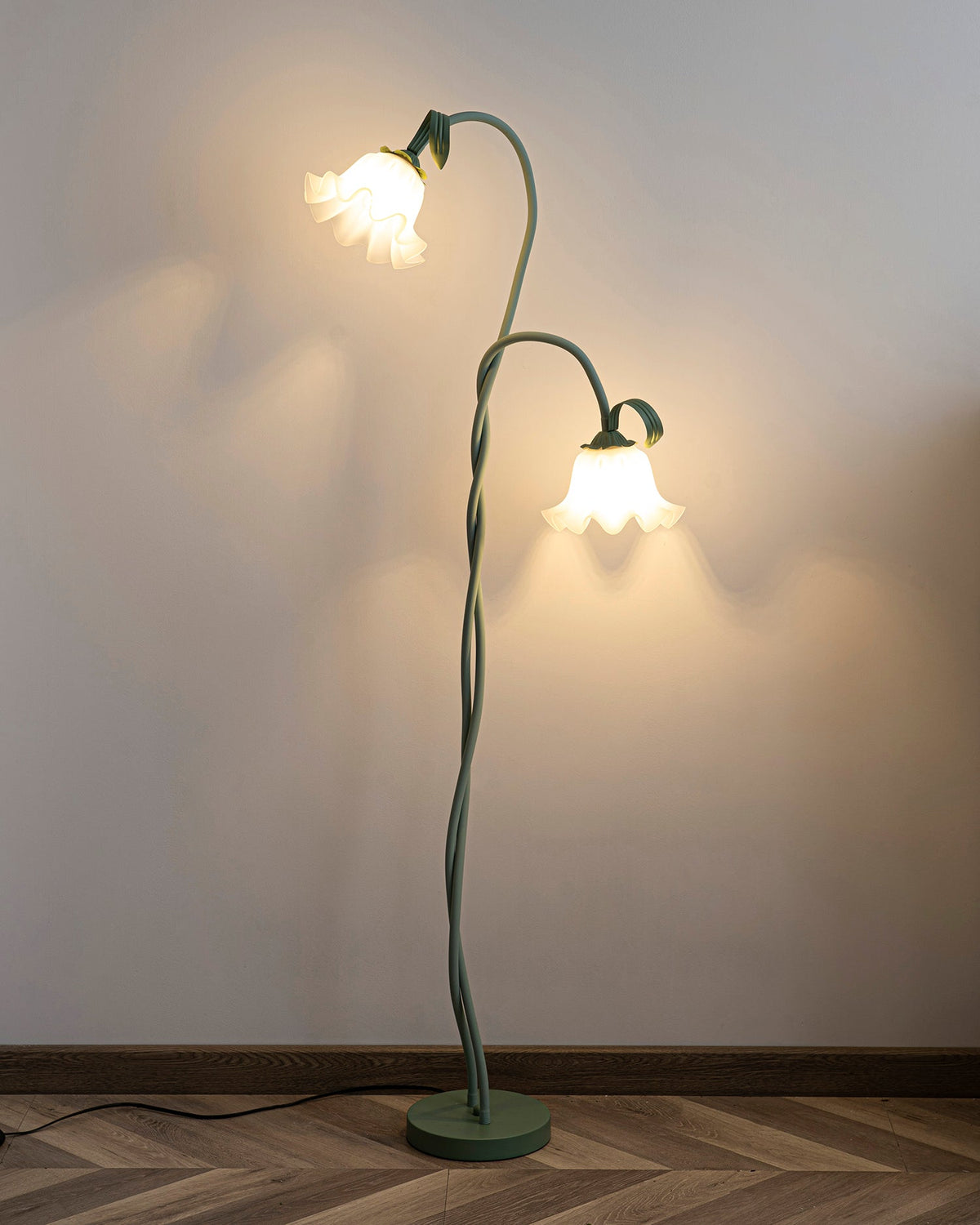 Calla lily floor lamp, green stem white shades - in a hallway, warm light