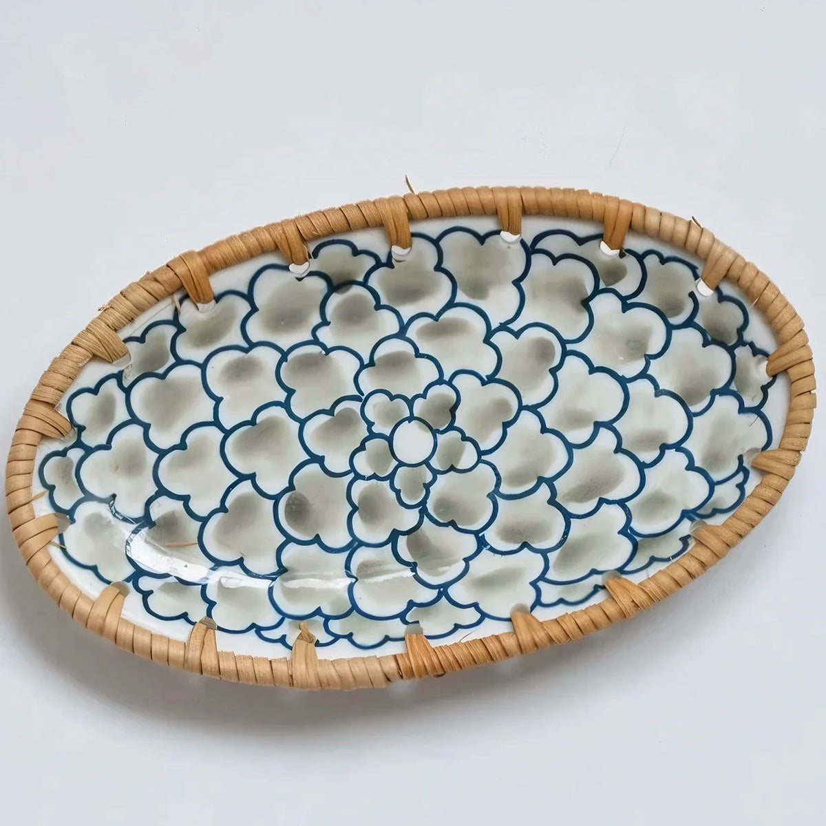 Oval ceramic serving plate with a light green flower pattern