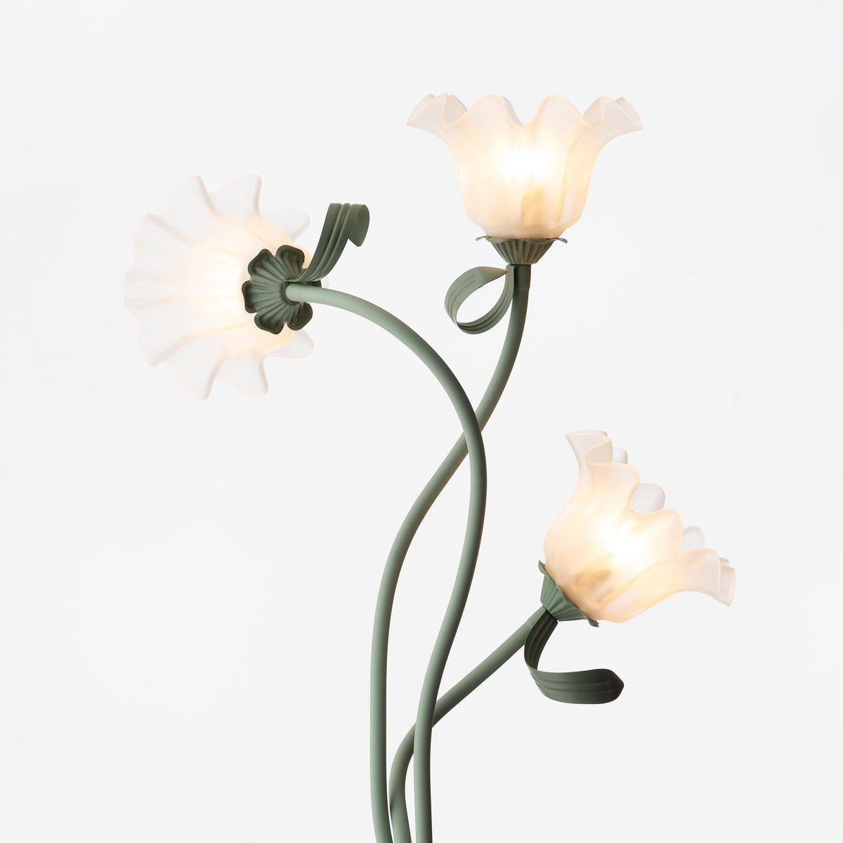 Calla lily floor lamp, green stem white shades - in a styled bedroom, warm light