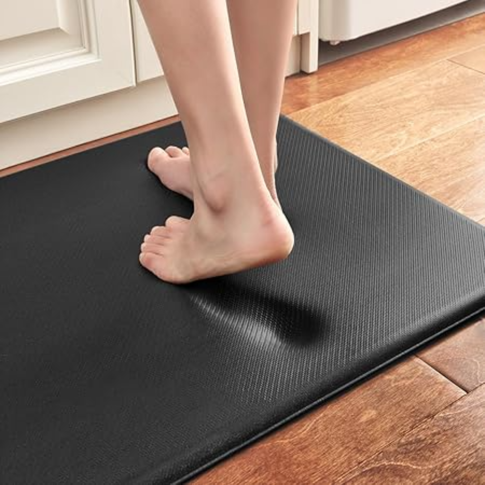 Foot pressing into the cushioned black anti-fatigue mat