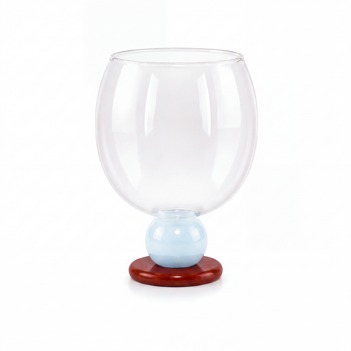 Balloon drinking glass with a light blue bead on a red stone base