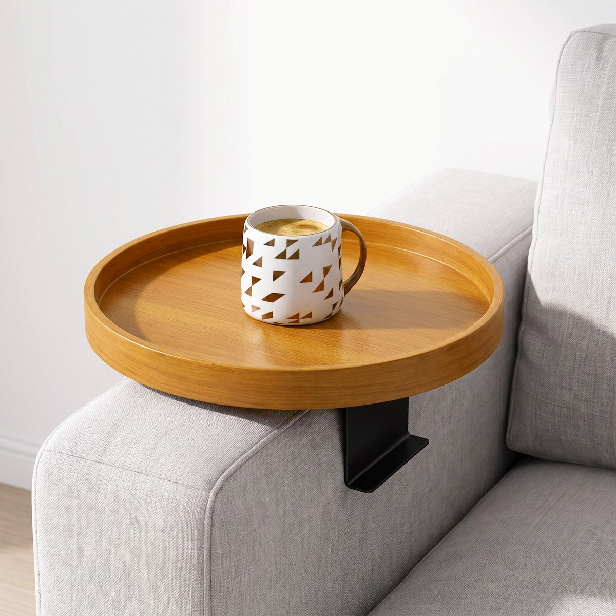 Golden Oak clip-on tray on a sofa arm with a mug of coffee