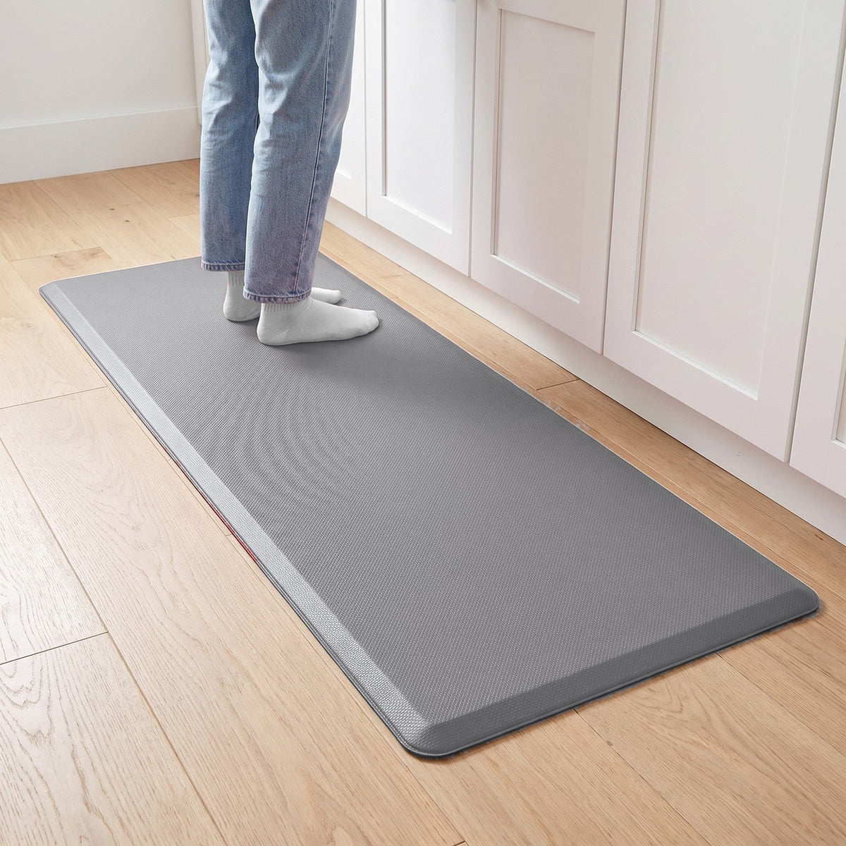 Comfort anti-fatigue kitchen mat in Light Gray in front of kitchen cabinets