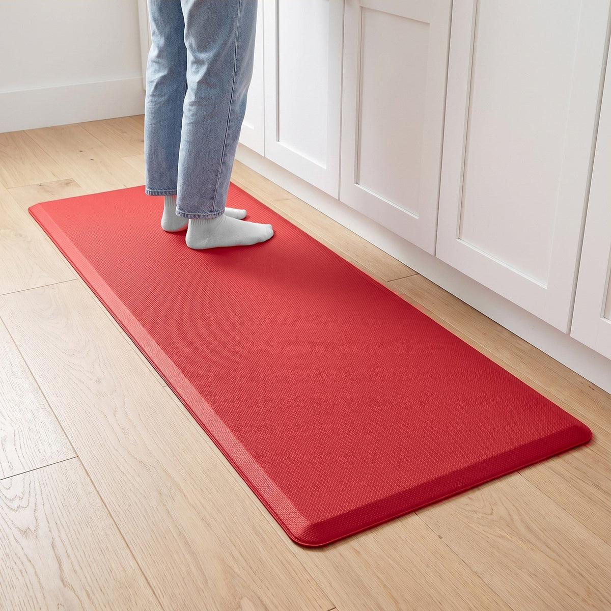Comfort anti-fatigue kitchen mat in Red in front of kitchen cabinets