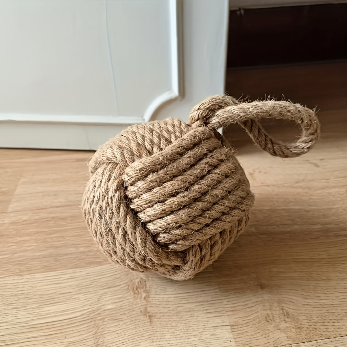 Natural brown rope ball door stop with a long carry loop