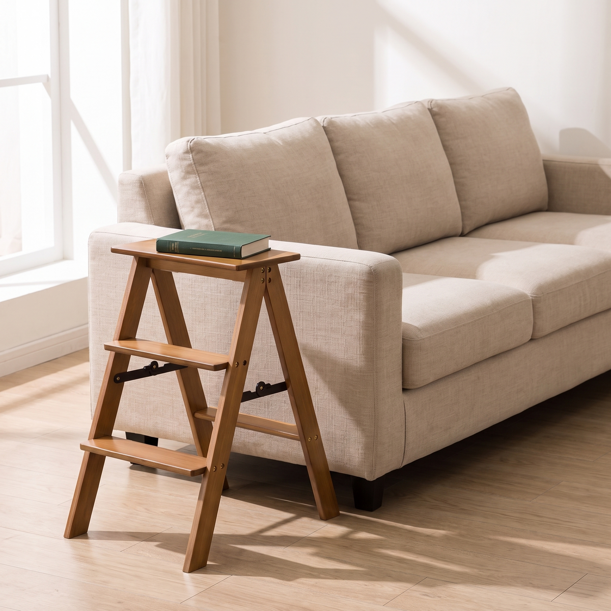 Bamboo step stool used as a side table with a book beside a sofa