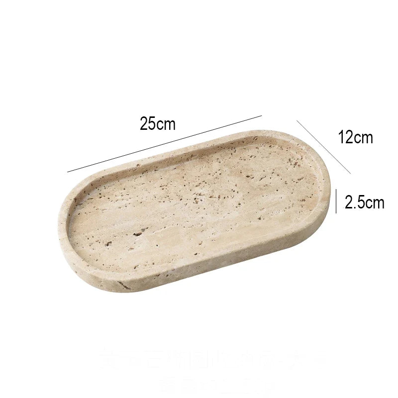 Oval travertine tray at an angle showing the low raised rim