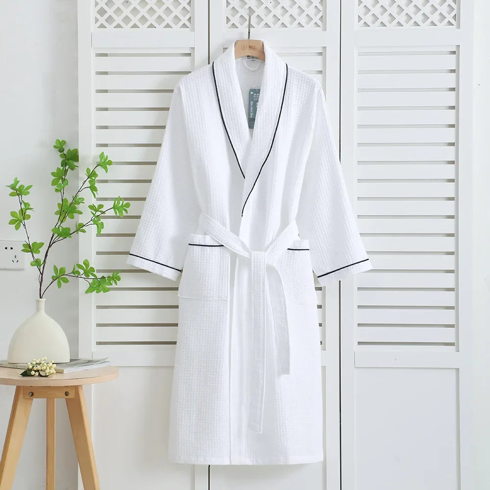 White waffle bathrobe with dark contrast piping on a hanger