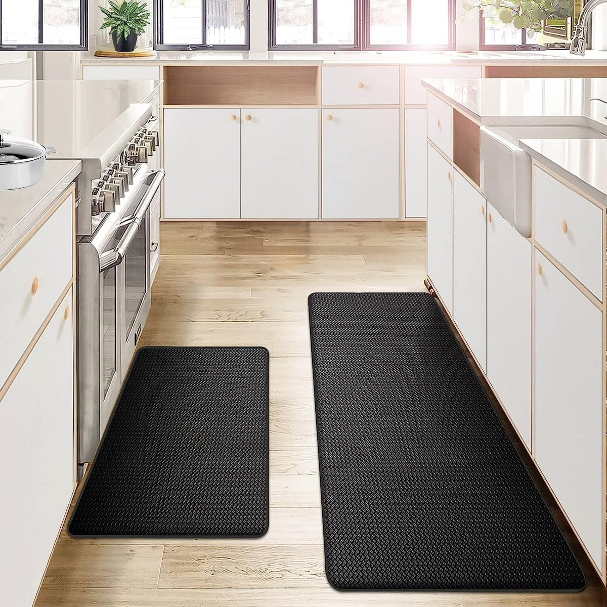 Black anti-fatigue kitchen mats in a white kitchen