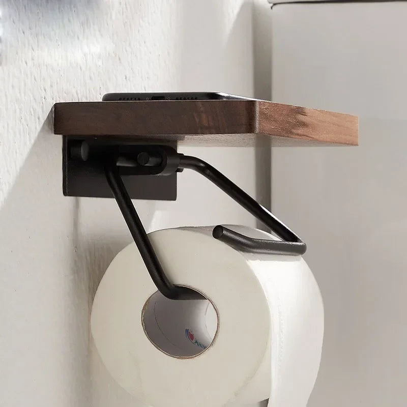 Side view of the black steel bracket under the walnut shelf holding a phone