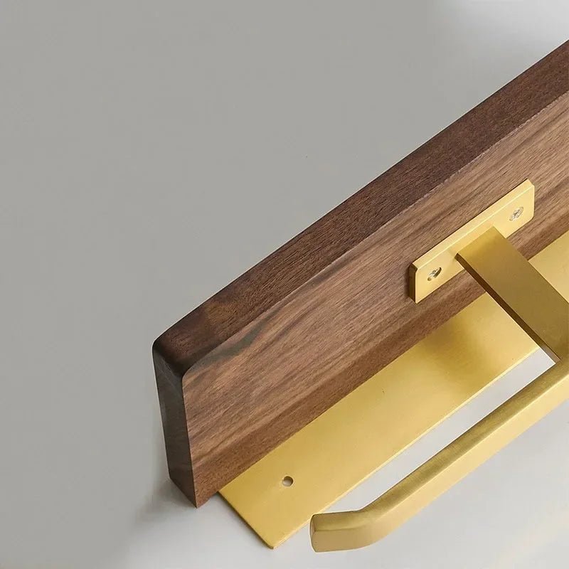 Underside of the walnut shelf showing the brass tone wall bracket