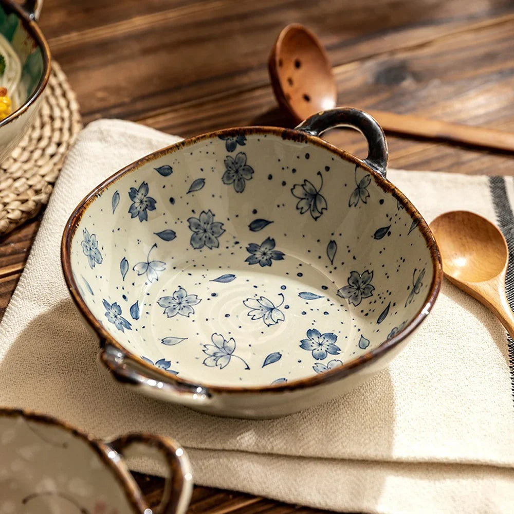 Blue flowers noodle bowl on a linen cloth beside a wooden spoon