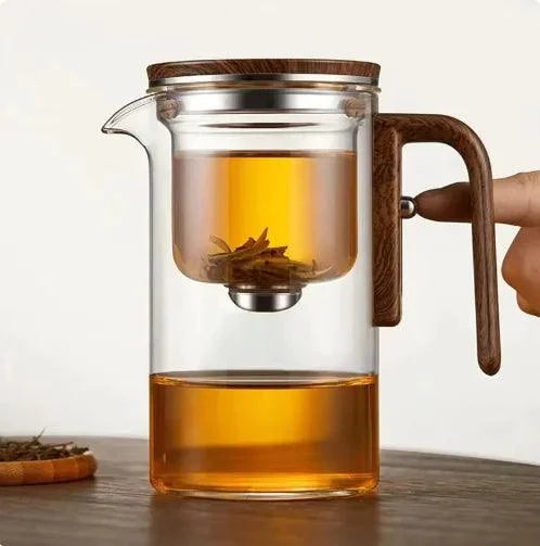 Borosilicate glass teapot with stainless steel loose leaf infuser on a light styled tabletop