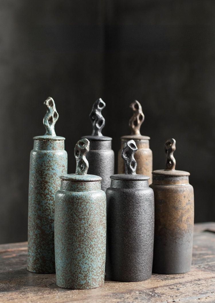 Handmade stoneware tea caddy with airtight ceramic lid styled with loose leaf tea on a wooden tray