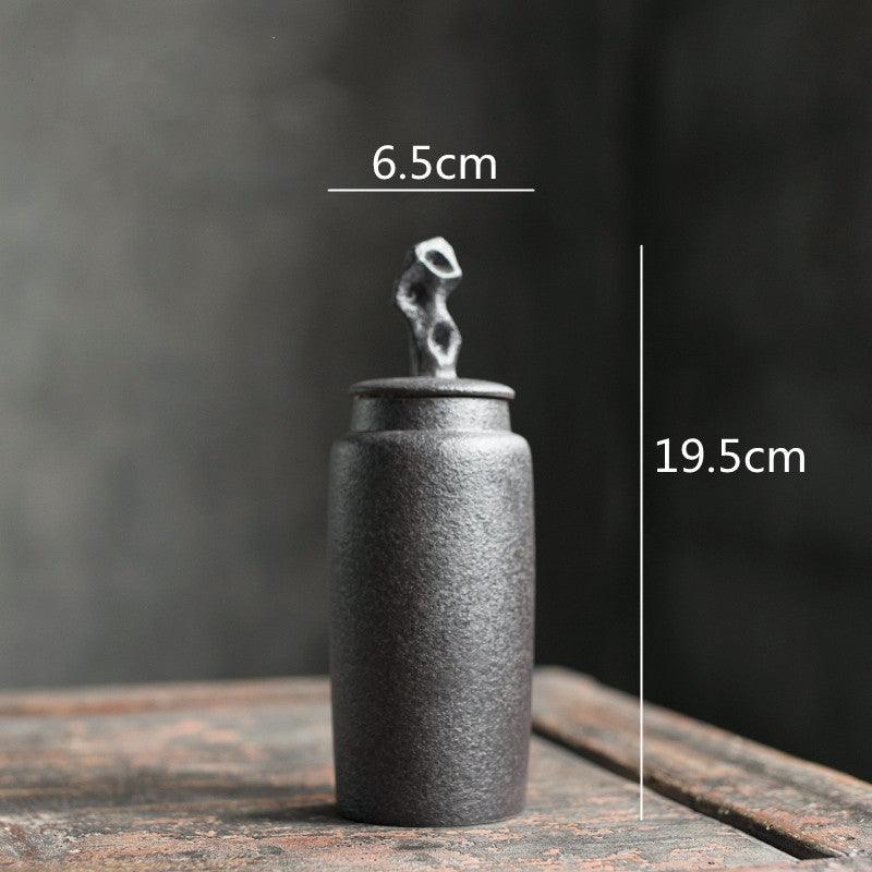 Handmade stoneware tea caddy with airtight ceramic lid in use during a calm morning tea ritual
