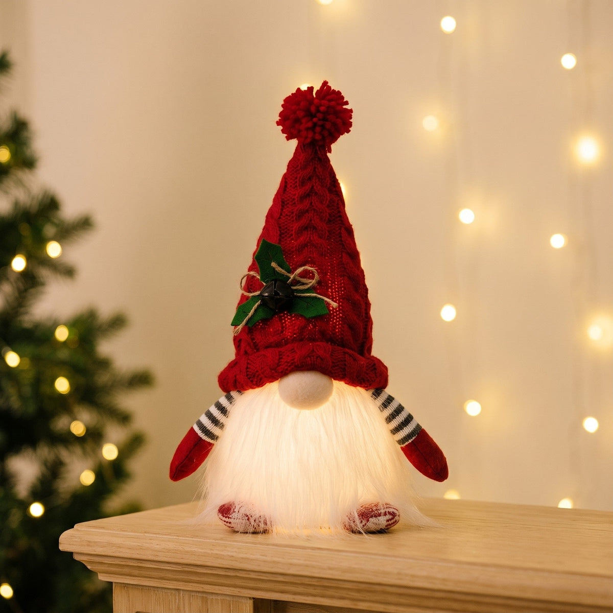 Red light-up Christmas gnome with the beard glowing on a mantel