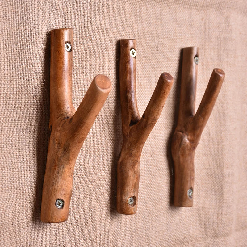 Three forked branch hooks with screw holes on a linen backdrop