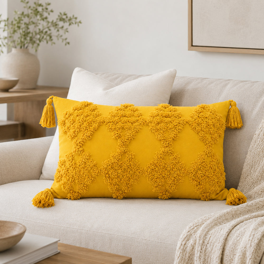 Yellow lumbar tufted tassel pillow styled in a neutral living room