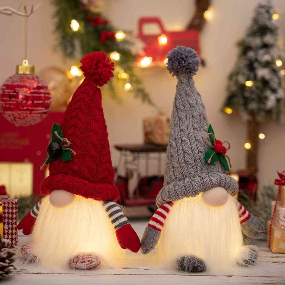 Red and gray Christmas gnomes glowing with the light on