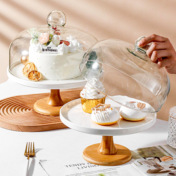 Footed cake stands with glass domes on wood pedestals