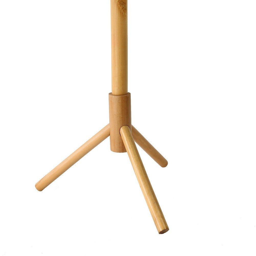 Close up of the splayed wooden base of the tree coat rack