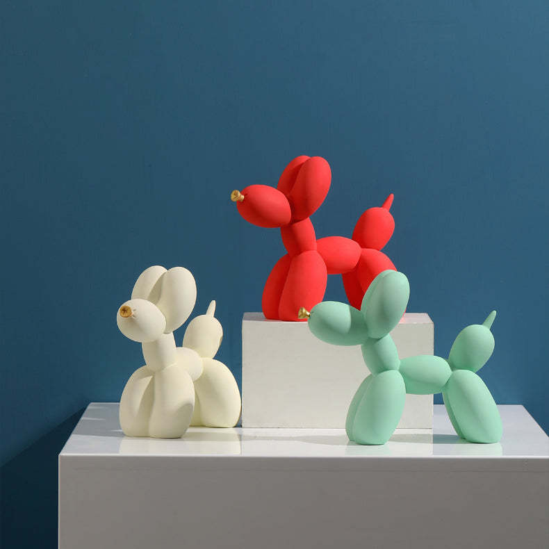 Beige, red and green matte balloon dogs on white blocks