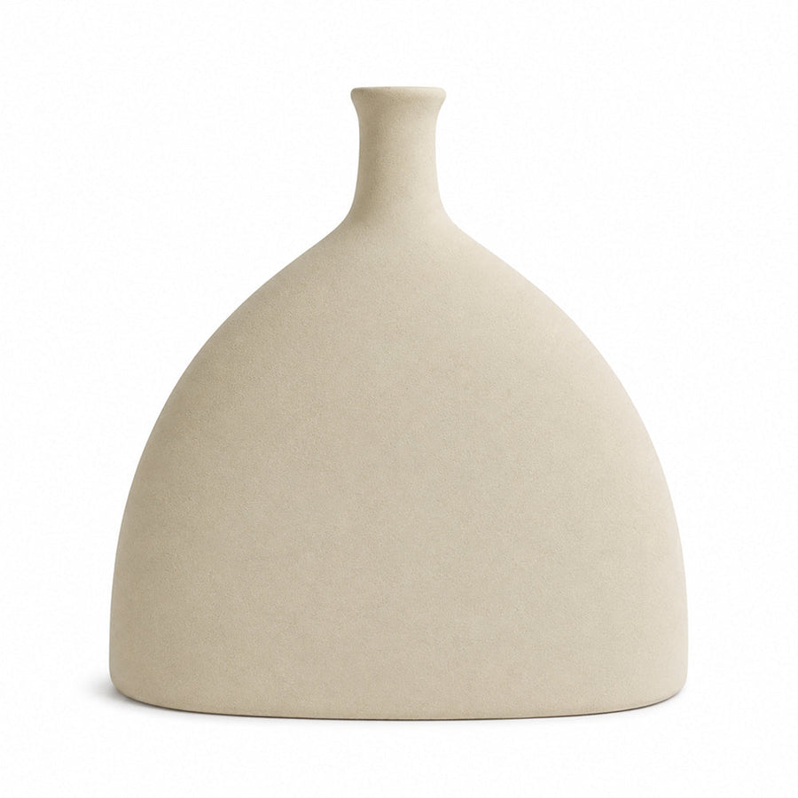 Unglazed ceramic silhouette vase at eye level against a plain wall