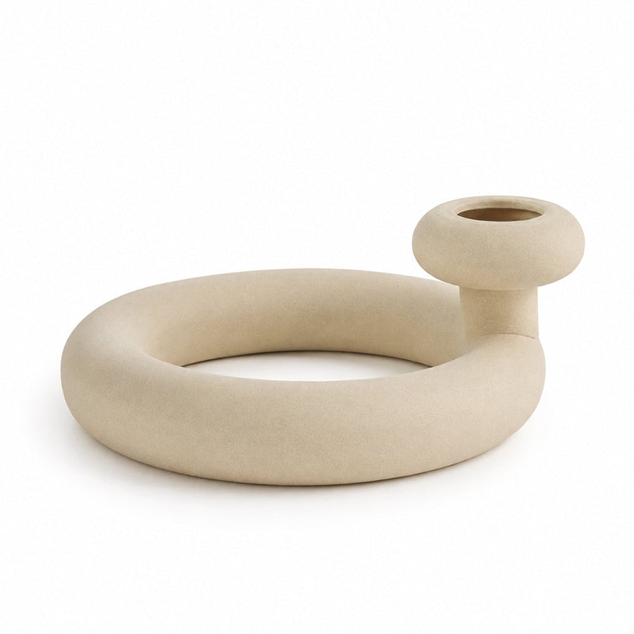 Looping matte unglazed ceramic vase on a shelf