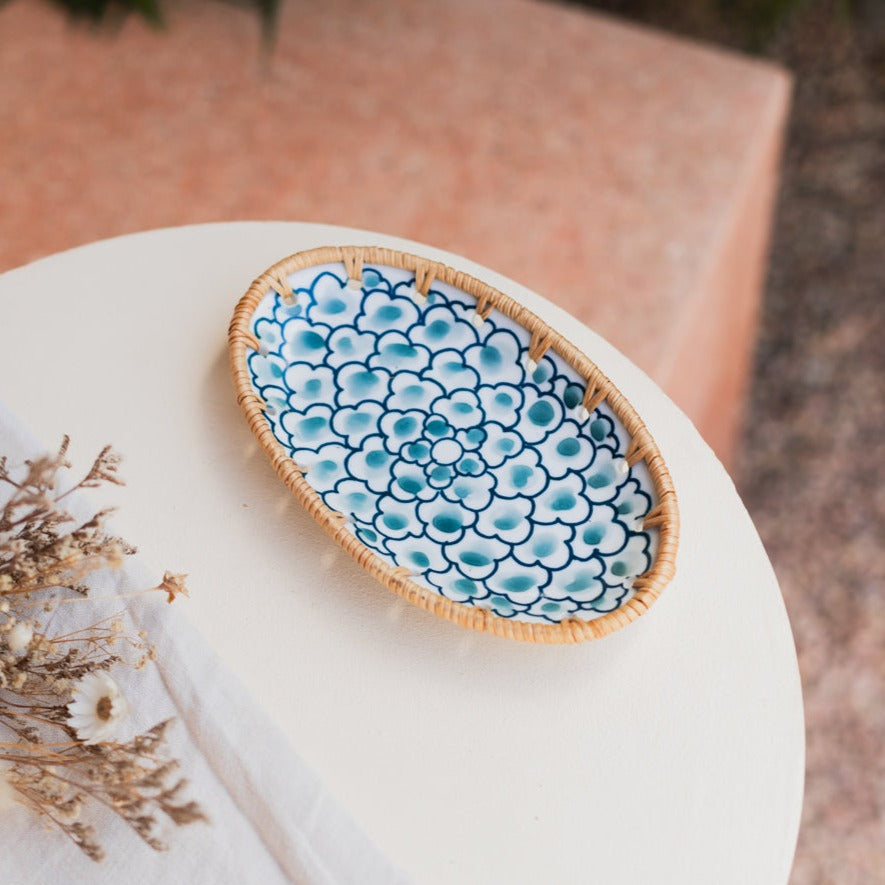 Oval serving plate with blue flowers on a white table