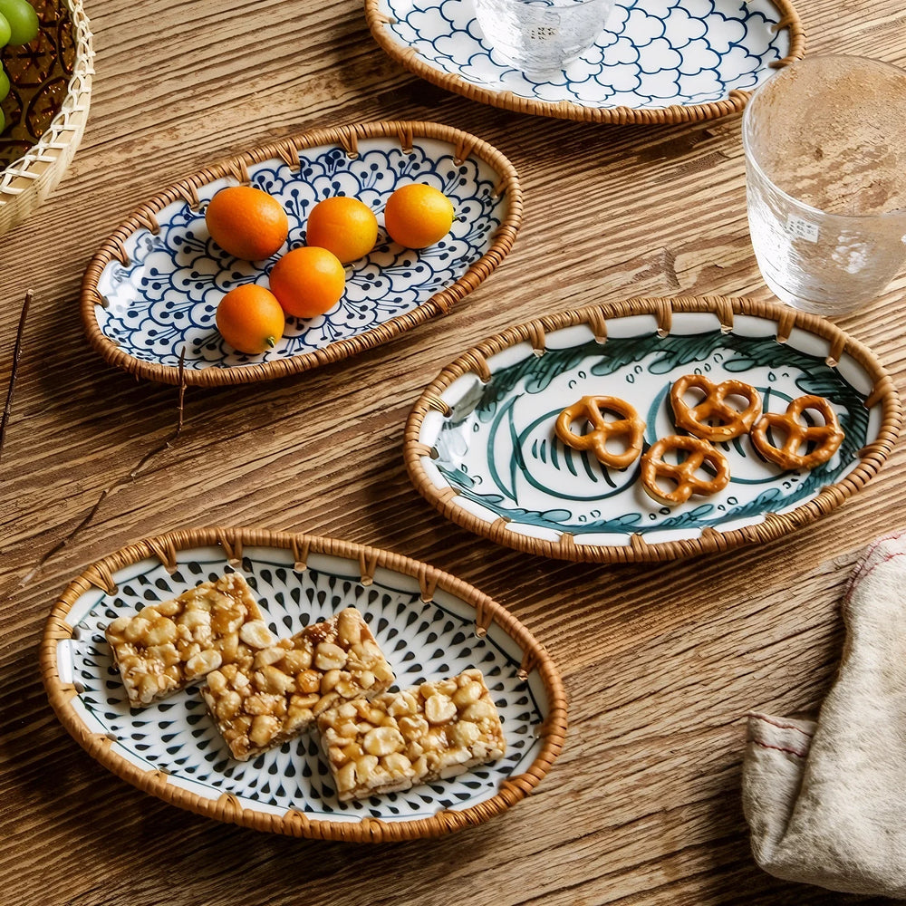 Oval ceramic serving plates with oranges and pretzels on a wooden table