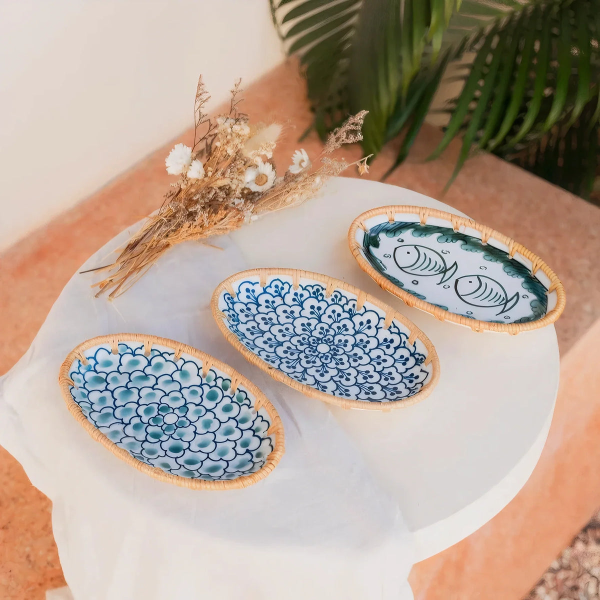 Three oval serving plates on a table outdoors