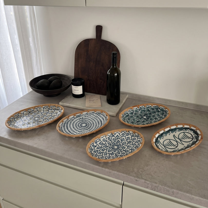 Oval serving plates laid out on a kitchen counter