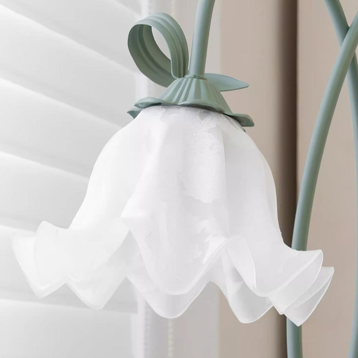 Calla lily floor lamp, green stem white shades - angled studio view, warm light