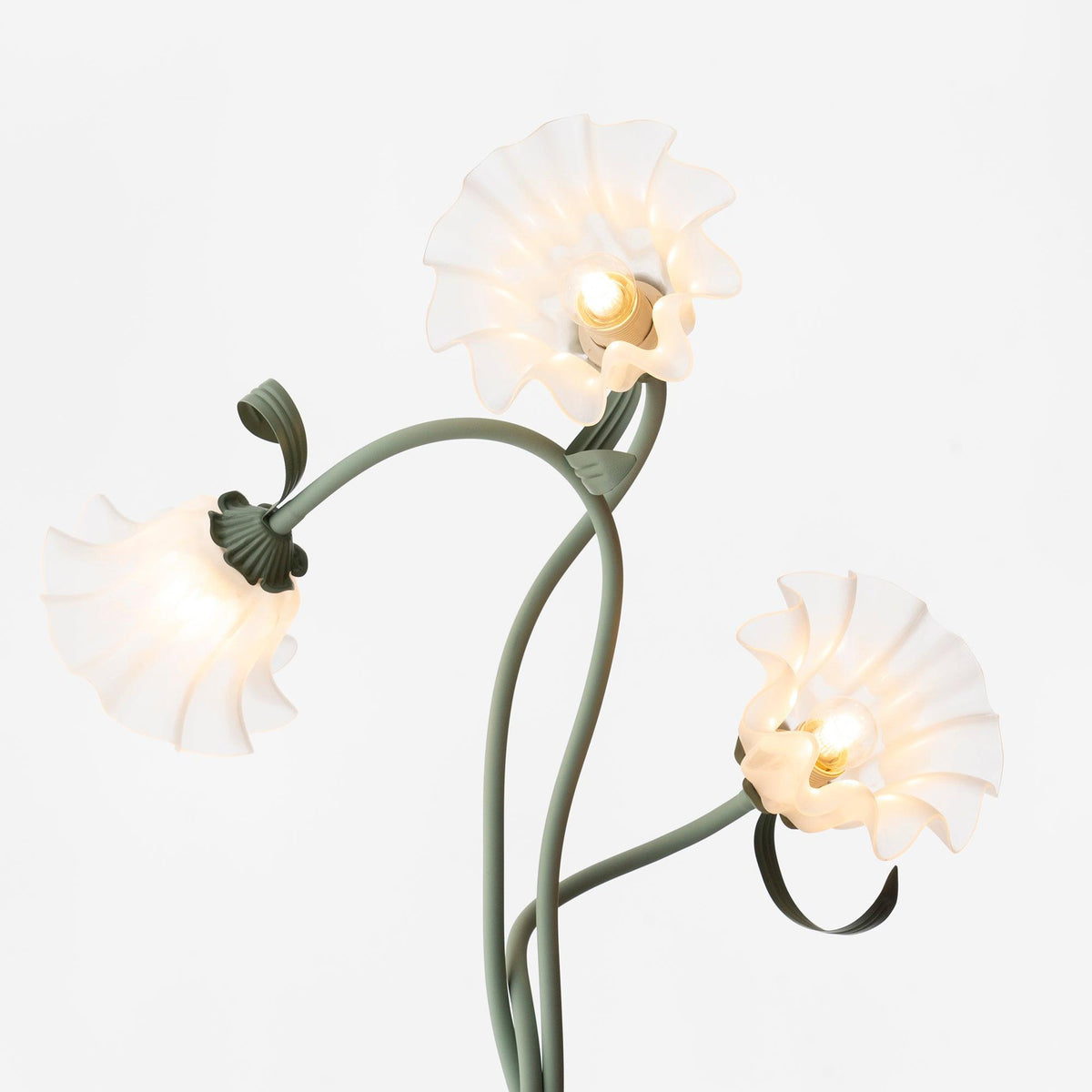 Calla lily floor lamp, green stem white shades - in a styled living room, warm light