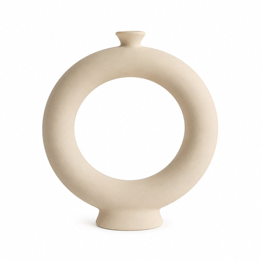 Matte unglazed ceramic ring vase standing on a shelf