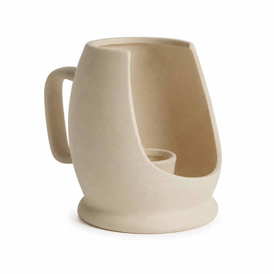 Sculptural matte unglazed ceramic vase on a shelf with dried stems