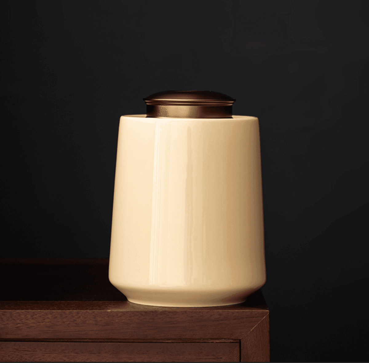 Airtight kitchen storage container with brass finish lid styled with loose leaf tea on a wooden tray