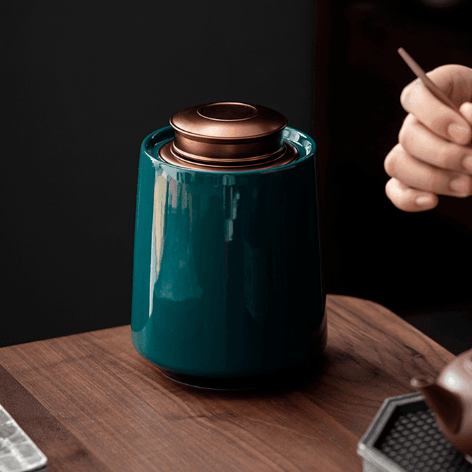 Airtight kitchen storage container with brass finish lid on a light styled tabletop