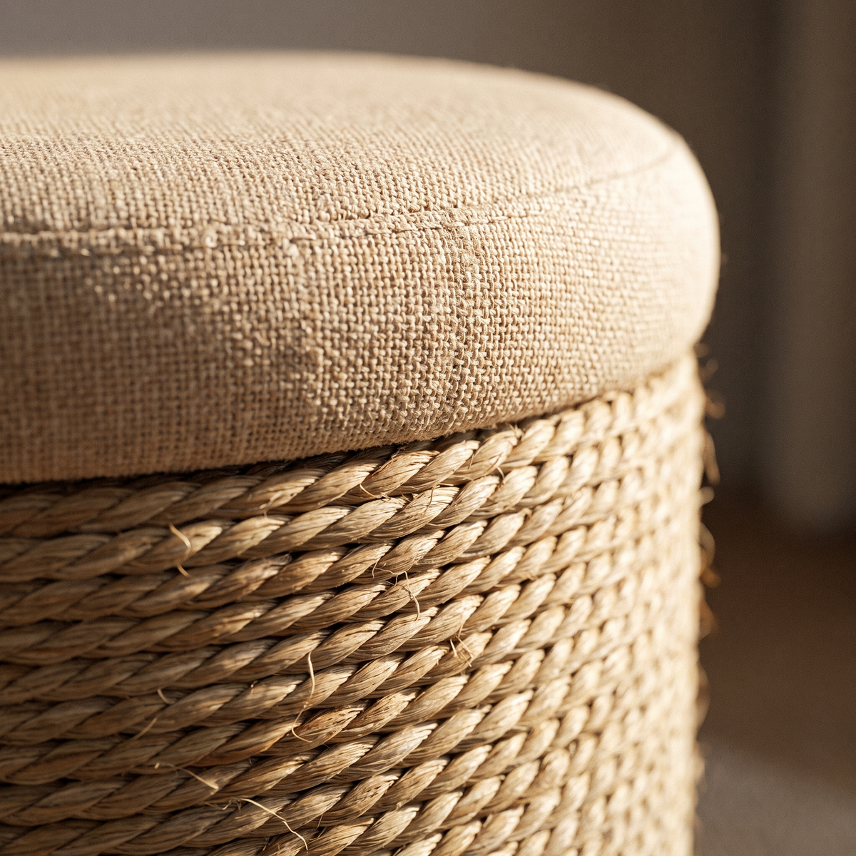 Close view of the padded lid and twisted weave of the storage ottoman