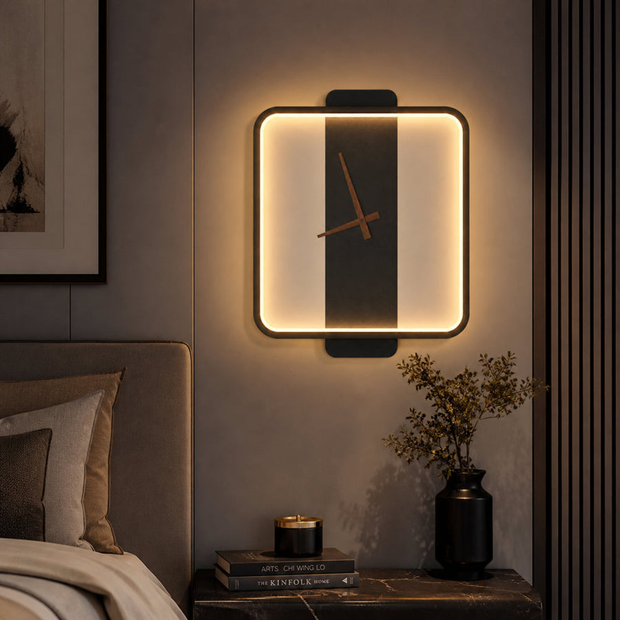 Black LED wall clock light glowing above a bedside table
