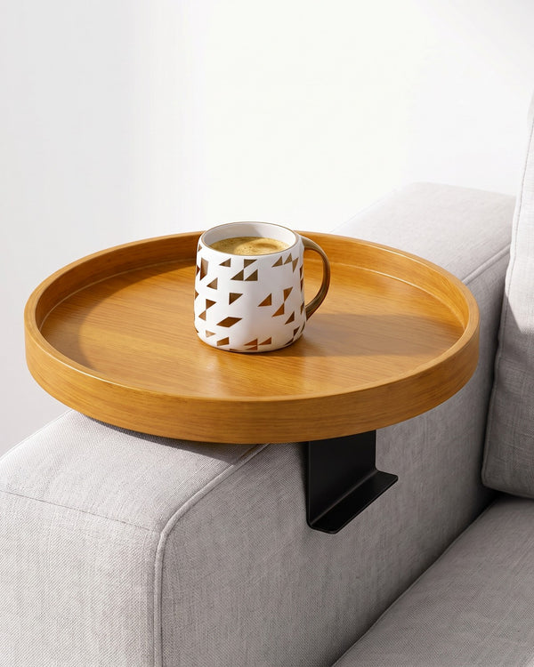 Golden Oak clip-on tray on a sofa arm with a mug of coffee